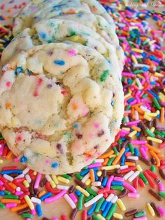 sprinkles and white chocolate chip cookies are on the table