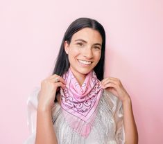 a woman wearing a pink scarf and smiling