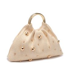 A perfect blend of chic style and natural vibes. Its open design, adorned with stud embellishments on woven straw, exudes an effortless charm. Carry it elegantly with the round top handle, and find convenience in the fabric-lined interior with a handy zip pocket. Item Type: Evening Bag Material: Straw Closure: Open Exterior Details: Woven Design, Stud Embellishments, Round Top Handle, Gold Hardware Interior Details: Fabric Lined, 1 Zip Pocket 14.77” L x 2.76” W x 6.89” H Luxury Summer Shoulder Bag With Pearl Handle, Luxury Chic Straw Bag, Luxury Cream Bags For Summer, Luxury Formal Bags With Interwoven Design, Luxury Elegant Festival Bag, Luxury Classic Shoulder Bag With Pebbled Texture, Luxury Summer Bags With Gold-tone Hardware, Luxury Embellished Summer Shoulder Bag, Luxury Handwoven Bags With Round Handle