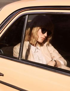 a woman sitting in the passenger seat of a car