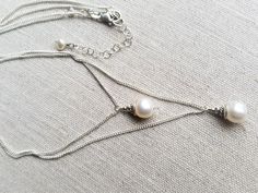 "Simple and elegant, this double strand pearl necklace will be a versatile piece in your wardrobe. Quality sterling silver cable chains hold one creamy white pearl on each (approximately 8 to10mm). Longer chain measures 18\", shorter chain measures 16\". Add length with included 2 inch extender chain." Elegant Silver Chain Layered Necklace, Elegant Layered Necklace With Silver Chain As A Gift, Elegant Layered Necklace With Silver Chain For Gift, Elegant Layered Silver Chain Necklace For Gifts, Elegant Silver Chain Layered Necklace As Gift, Double Strand Pearl Layered Necklace Gift, Double Strand Pearl Layered Necklace As Gift, Silver Double Strand Pearl Necklace With Pearl Drop, Double Strand Pearl Layered Necklace For Gift