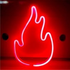 a red neon sign sitting on top of a table