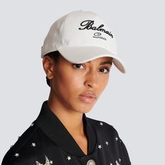 Get ready for a stylish and sporty look with the Balmain Embroidered Logo Baseball Cap. Made from high-quality materials, this cap features a bold and eye-catching embroidered logo. Perfect for adding a touch of luxury to any casual outfit. Upgrade your wardrobe today! Casual Baseball Cap With Logo Detail, Designer Streetwear Cap, Designer Baseball Cap For Streetwear, Classic Visor Baseball Cap With Embroidered Logo, Luxury Baseball Cap For Streetwear With Visor, Luxury Visor Baseball Cap For Streetwear, Luxury Streetwear Baseball Cap, Luxury White Snapback Hat, Luxury White Baseball Cap