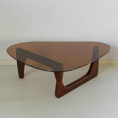 an oval glass coffee table with wooden legs