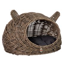 a cat bed made out of wicker with an animal's head on it