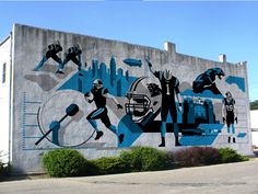 a mural painted on the side of a building depicts football players and other sports related items