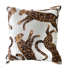 an animal print pillow with leopards on the front and back, sitting on a white surface