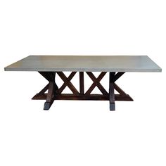 a concrete table with two wooden legs and a metal plate on the top, against a white background