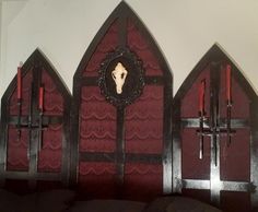 an ornate gothic church with red walls and pews, decorated with cross - shaped decorations