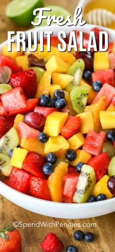 fresh fruit salad in a white bowl on a wooden table