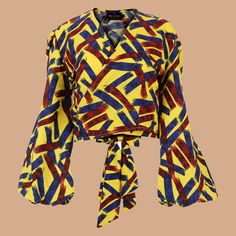 This true wrap blouse features long lantern sleeves with elastic cuffs and adjustable ties that can be worn in front or back. Pair with the Rume Wrap Skirt or Rume Pants for a chic and coordinating ensemble. Made in Nigeria Semi Cropped View Size Chart Multicolor Printed Blouse With Lantern Sleeves, Multicolor Wrap Blouse, Bohemian Multicolor One-size Wraps, African Clothing Stores, Multicolor Printed Cover-up With Kimono Sleeves, Semi Cropped, Multicolor Abstract Print V-neck Blouse, Home Decor Products, Wrap Blouse