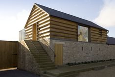 a wooden house with stairs leading up to it