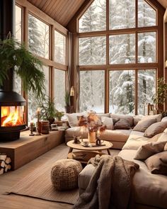 a living room filled with furniture and a fire place in front of a large window