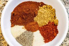 spices in a white bowl on a granite counter