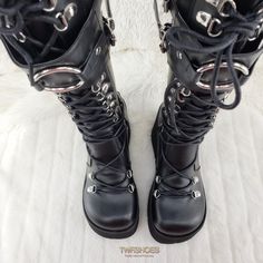 KERA-2004 1/2" PFSize: 6-114 1/2" (114mm) Platform D-Ring Lace-Up Knee High Boots Featuring Adjustable Shield w/ an Oversized O-Ring, Full Length Back Metal Zip Closure ******Please note****** Due to High Volume Sales Pleaser/ Demonia has stopped all Direct Shipping Orders may take up to 6 weeks to arrive as we have to order them in to ship to you Shop Our collection of Pleaser In House for FAST Shipping!! contact us with any questions or concerns before ordering or if your size is not listed it Black Spiked Alternative Boots, Black Alternative Boots With Spikes, Alternative Style Black Spiked Boots, Black Lace-up Boots For Cosplay, Emo Leather Boots With Round Toe, Black Leather Emo Moto Boots, Gothic Black Boots With Spikes, Emo Style Leather Boots With Round Toe, Emo Style Black Leather Moto Boots