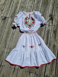 Hungarian Matyó handembroidered dress, Traditional hungarian floral embroidered dress . This dress is new Peasant dress, colorful embroidered dress, handsmocked Beautiful wide shape boho, hippie, folk dress with floral embroidered pattern.  Handmade dress  M size Waist expand max 32 -  33"  lenght: 39 5" Lenght from waist (skirt):21,5 " Hand wash only. If you are buying several pieces I can combine postage at the time of mailing. If you have any question please don't hesitate to contact me, For Folk Style Embroidered Dress For Spring, Traditional Embroidered Peasant Dress, Folk Style Embroidered Dress With Multicolor Embroidery, Peasant Embroidered Dress For Festivals, Peasant Style Multicolor Embroidered Festival Dress, Handmade Folk Dresses For Spring, Spring Peasant Embroidered Dress With Multicolor Embroidery, Handmade White Folk Dress, Hungarian Dress