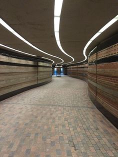 an empty brick walkway in the middle of a building