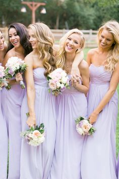 the bridesmaids are posing for pictures on their wedding day