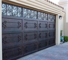 a brown garage door with intricate iron work