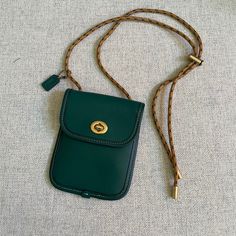 Coach Leather Turnlock Pouch Crossbody Color: Dark Green Hunter In Really Great Condition. Dimension: 4" (L) X 5 1/4" (H) X 1/4" (W) Cleaning Out My Closet And Used Only A Few Times. Super Cute And Can Fit Cards Or A Lipstick. Thank You! Luxury Green Pouch For Everyday Use, Classic Green Shoulder Bag With Mobile Phone Holder, Classic Green Shoulder Bag With Phone Holder, Coach Pouch Bag With Cell Phone Pocket, Coach Leather Shoulder Bag With Mobile Phone Holder, Coach Leather Shoulder Bag For Mobile Phone, Coach Leather Mobile Phone Shoulder Bag, Coach Mobile Phone Pouch Bag, Coach Mobile Phone Bag For Daily Use