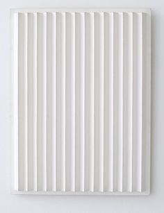 a white paneled wall with vertical lines on the bottom and one horizontal line at the top