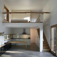 an open floor plan with stairs leading up to the upper level and kitchen below it