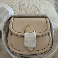 Brand New Coach Beat Saddle Leather Brass/Ivory Bag In Original Packaging Price Is Firm Glovetanned Leather Inside Zip And Slip Pockets Snap Closure, Fabric Lining Outside Open Pocket Detachable Strap With 24" Drop For Shoulder Or Crossbody Wear 8 3/4" (L) X 7" (H) X 2 1/4" (W) Style No. C0749 Designer Beige Top Handle Shoulder Bag, Designer Beige Crossbody Bag, Designer Beige Shoulder Bag With Detachable Handle, Luxury Beige Shoulder Bag Satchel, Designer Beige Bags With Gold-tone Hardware, Designer Beige Shoulder Bag For Errands, Designer Beige Shoulder Bag With Removable Pouch, Designer Cream Bag With Leather Lining, Luxury Beige Crossbody Shoulder Bag