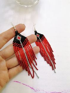 Elegant Red Tassel Earrings With Dangling Beads, Red Long Drop Earrings With Dangling Beads, Red Tassel Earrings With Fringe And Round Beads, Red Fringe Tassel Earrings With Round Beads, Red Dangle Tassel Earrings With Fringe, Red Long Drop Beaded Earrings As Gift, Red Long Drop Beaded Earrings In Bohemian Style, Red Long Drop Beaded Earrings For Gift, Red Long Drop Beaded Bohemian Earrings