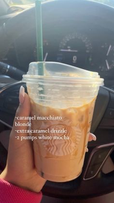 a person holding up a starbucks drink in their hand with the caption, caramel macchiato and extra caramel drizzle