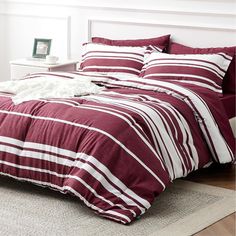 a red and white striped comforter set on a bed