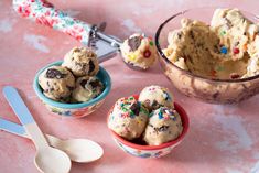 ice cream with sprinkles in bowls next to spoon