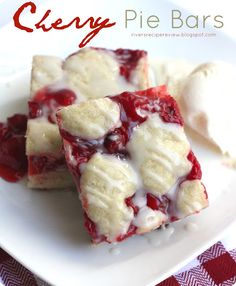 cherry pie bars on a white plate with ice cream and cherries in the background