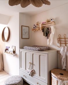 a baby's room with an animal print crib and toy storage bins