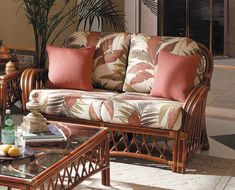 a living room filled with furniture next to a table and potted palm tree in the corner