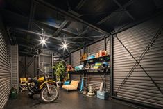 a motorcycle is parked in the garage next to some shelves with plants and other things