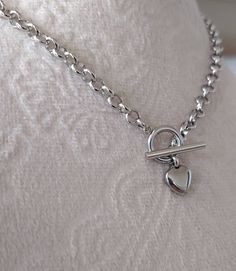 Handmade Lightweight All Silver Color Stainless Steel Heart Necklace, Stainless Steel Toggle Closure Stainless Steel Silver Color Rolo chain, ~5mm wide Stainless Steel Heart Charm, ~10mm **Total length is for the chain and toggle only not including the heart pendant** Same Necklace available in Gold Color stainless Steel, please see the below listing: https://www.etsy.com/listing/1108247644/gold-heart-necklace-or-bracelet-dainty?click_key=83fb19d44276289d12c77af145231997ccad49ff%3A1108247644&cli Imp Oc, Prom Vibes, Heart Toggle Necklace, Prom Inspo, Diy Jewelry Unique, Toggle Necklace, Bracelet Dainty, Heart Chain, Necklace Chain Lengths