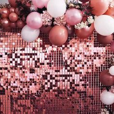 some balloons and other items are on the floor in front of a wall that is covered with sequins