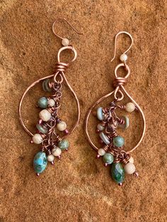 "Copper teardrop hoops are of hammered copper. Figure eight link chain is adorned with cream and light turquoise multi shaped beads for a beautiful dangle. Teardrop is 2 3/4\" tall from top of ear wire and 1 3/8 wide at the widest part.  New item for Spring/Summer Free shipping to USA" Beaded Copper Teardrop Jewelry, Copper Beaded Teardrop Jewelry, Copper Teardrop Beaded Jewelry, Beaded Copper Teardrop Earrings, Copper Beaded Teardrop Earrings, Wire Wrapped Copper Beaded Dangle Earrings, Copper Teardrop Beaded Earrings, Bohemian Teardrop Copper Hoop Earrings, Wire Wrapped Copper Teardrop Dangle Earrings