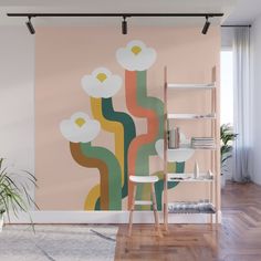 a wall mural with flowers on it in a living room next to a book shelf