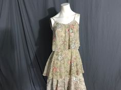 "Vintage floral ruffle tiered dress, tag is faded so follow measurements. Dress feels like a cotton material, zips up the back. Pattern is floral, dress is tan, has spaghetti straps, is in great condition, measurements are Bust up to 34\" Waist up to 27\" Hips up to 34\" Length 44\"" Spring Cottagecore Tiered Dresses, Vintage Spring Dress With Spaghetti Straps, Vintage Spring Dresses With Spaghetti Straps, Vintage Dresses With Spaghetti Straps For Spring, Vintage Spaghetti Strap Dresses For Spring, Vintage Tiered Skirt Dress For Spring, Vintage Tiered Skirt Dresses For Summer, Cottage Dress, Ruffle Tiered Dress