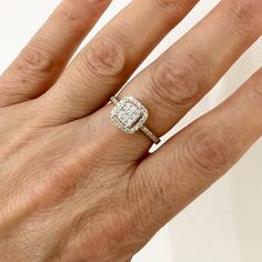 a woman's hand with a diamond ring on top of her finger and an engagement band