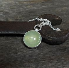 A cool, green translucent Prehnite gemstone with natural inclusions is nestled in sterling silver and hangs from a sterling silver chain. Perfect everyday accessory. This one-of-a-kind necklace is ready to ship. Prehnite: 14mm Chain: Choose your length. Will arrive gift-boxed. My jewelry is handcrafted one piece at a time by me in my home studio in Portland, Oregon. If I can help you with any questions about this piece or any of my other products, please feel free to contact me: hello@paulla.com PIN IT on PINTEREST FOLLOW on Instagram - @paullatewksburyjewelry LIKE IT on Facebook - @paullatewksburyjewelry  DOMESTIC SHIPPING Items will ship free via USPS.  INTERNATIONAL SHIPPING Items will ship free via USPS First Class Int'l. Green Prehnite Necklace For Gift, Green Amethyst Necklace For Gift, Green Gemstone Necklace, Cool Green, Layered Necklaces Silver, Necklace Green, Everyday Accessories, Layering Necklace, Green Necklace