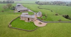 an aerial view of a large house in the country