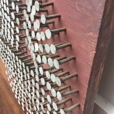 several nails are arranged on a wooden board