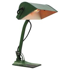 a green table lamp with a white light on it