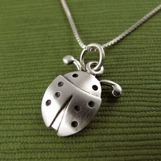 "This pretty little ladybug is made of sterling silver. The pendant is TINY, measuring about 1/2\" (1.2 cm) in length.  Super cute! You can purchase just the pendant/charm, or complete the necklace with a sterling silver chain.  For the matching ladybug earrings:  www.etsy.com/listing/228278367/tiny-ladybug-earrings © Stick Man Creations This is our own original design, handcrafted by us, and signed on the back with our logo.   If you want to read more about the process, click here:  www.etsy.co Dainty Charm Necklace Gift, Silver Oval Pendant Charm Necklace In Sterling Silver, Silver Sterling Silver Oval Pendant Charm Necklaces, Sterling Silver Charm Necklace With Oval Pendant, Silver Sterling Silver Charm Necklace With Oval Pendant, Cute Silver Pendant Charm Necklace, Cute Silver Charm Necklaces With Lobster Clasp, Cute Sterling Silver Pendant Charm Necklaces, Cute Sterling Silver Pendant Charm Necklace