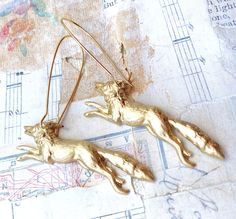 A wonderful detailed forest fox charm highlights these woodland earrings. This detailed golden raw brass fox charm hangs from simple gold plate ear wires. The fox measures approx. 1 3/4 inches across and the earrings measure 2 3/4 inches. PLEASE NOTE: ►There are NO returns on earrings (for health/hygiene reasons) Your foxy earrings will arrive in a beige cotton drawstring bag with a gift tag. Perfect for gift giving or a fun little treat for yourself. This jewelry bag can be re-purposed to hold Coyote Running, Wolf Earrings, Fox Charm, Forest Earrings, Brass Fox, Vintage Running, Woodland Earrings, Gold Fox, Fox Earrings