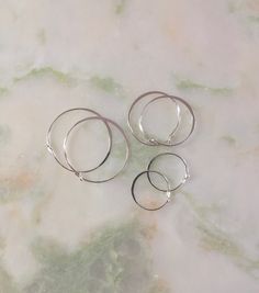 These simple sterling silver hoop earrings are slightly hammered on the side. So they're minimalist earrings that you can combine with others for a more punky look, or add a little charm on the hoop for the piece to stand out more on its own. These hoops will go well with other pieces of geometric jewelry or simple jewelry. There are multiple options for the size of these minimalist circle earrings. I also have simple tube hoops over here: https://www.etsy.com/illustrationist/listing/647764915/ Minimalist Jewelry Silver, Minimalist Winter, Winter Jewelry, Minimalist Gifts, Sterling Silver Hoop Earrings, Geometric Jewelry, Fall Jewelry, Sterling Silver Hoops, Simple Jewelry