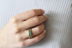 "Hadas shaham gold concrete band, this contemporary modern ring is made from brass plated gold, cast with a polymer concrete inlay and Wrapped with red nylon threads. The clean Minimalist design makes this unique and timeless piece and it looks great alone or stacking. * The Ring is available also in silver version - http://etsy.me/2zf3I1F * This Ring can also be ordered in solid gold - You can contact the studio for a quote through etsy. * Feel free to contact me with any questions or requests. Modern Brass Stackable Rings For Gift, Modern Brass Stackable Rings As Gift, Handmade Minimalist Brass Stackable Rings, Minimalist Green Stackable Rings For Everyday, Minimalist Everyday Green Stackable Rings, Minimalist Brass Stackable Rings, Minimalist Green Stackable Rings, Green Minimalist Stackable Rings, Concrete Inlay