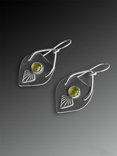 Vesuvianite Art Deco Spade Earrings On the front is a green vesuvianite over a stamped design, and a detailed Art-Deco inspired pattern covers the back of these spade-shaped earrings.  * These earrings are about 1 3/4" long by about 3/4" wide. * The natural round vesuvianite cabochons are 6mm in diameter. * The ear hooks are hand-formed 20 gauge hypoallergenic argentium sterling silver. * This piece is made entirely with sterling and fine silver. * Your purchase will be delivered in elegant packaging, ready to give or wear. * Gift wrapping is available at checkout. 🌿 Please get in touch with any questions! Elegant Green Earrings With Artistic Design, Green Artisan Gemstone Earrings, Green Gemstone Artisan Earrings, Artisan Green Gemstone Earrings, Artistic Green Sterling Silver Earrings, Green Artisan Pierced Earrings, Artisan Green Earrings With Artistic Design, Unique Hand Forged Green Earrings, Green Earrings With Oxidized Finish